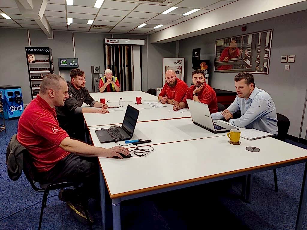 team ev page 2 pic-min JC Metalworks employee in a team meeting